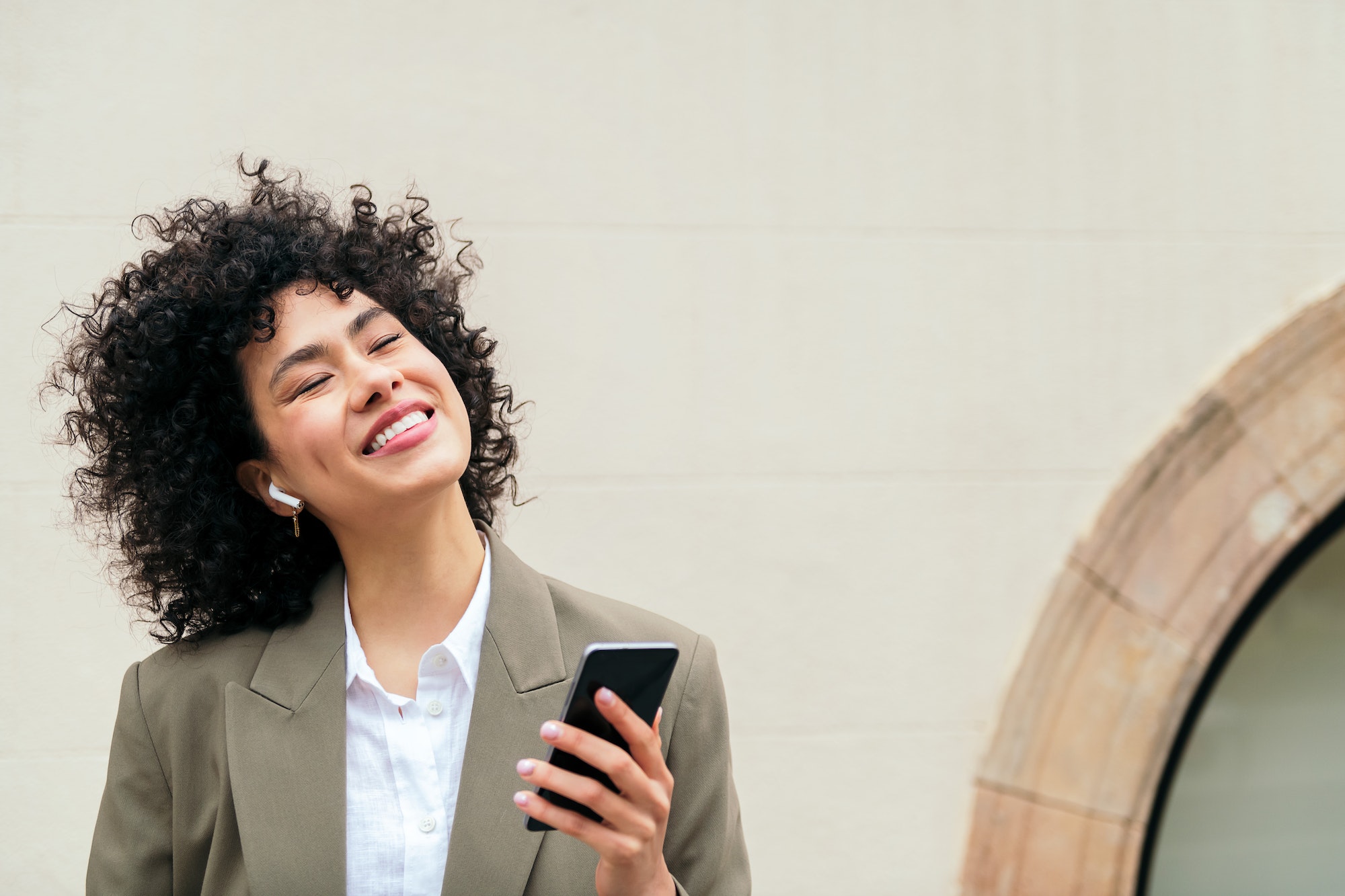 happy woman with earphones smiles listening music